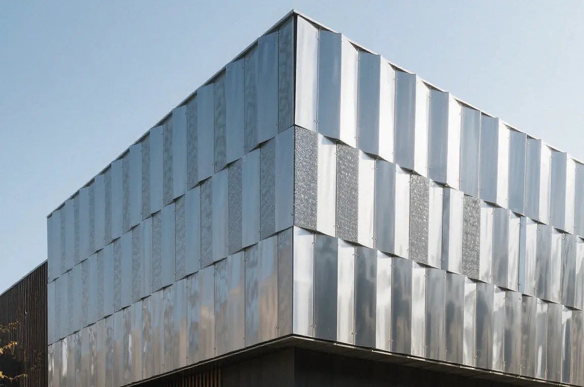 Brushed stainless steel decorative panels used as exterior cladding on a commercial building.