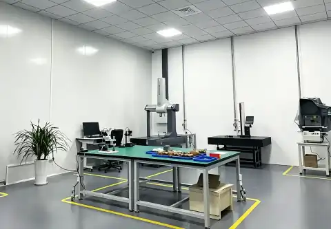 Clean precision inspection lab equipped with CMM coordinate measuring machine and optical testing equipment for metal component dimensional quality checks