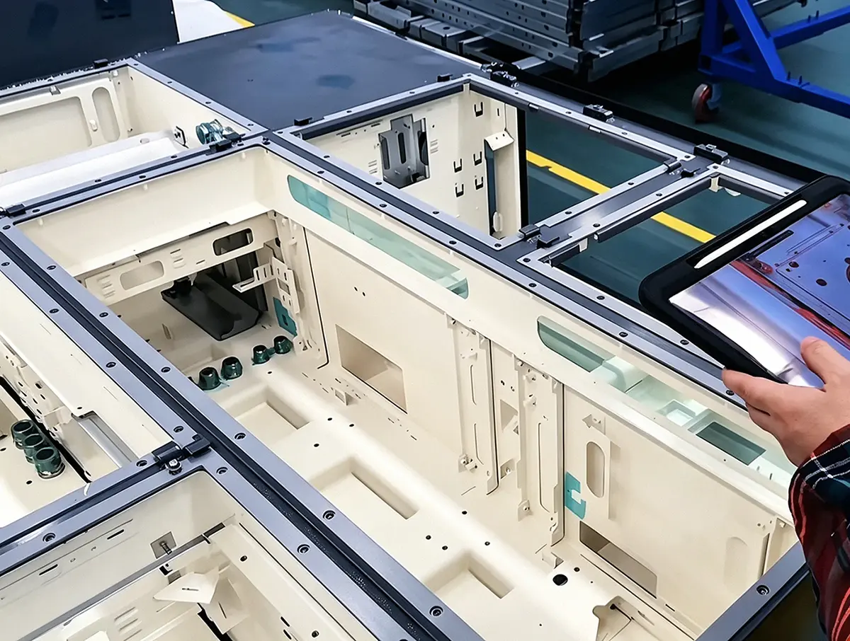 Factory quality inspector checking custom sheet metal enclosure assembly, full in-house sheet metal fabrication quality control including CNC machining laser cutting bending welding