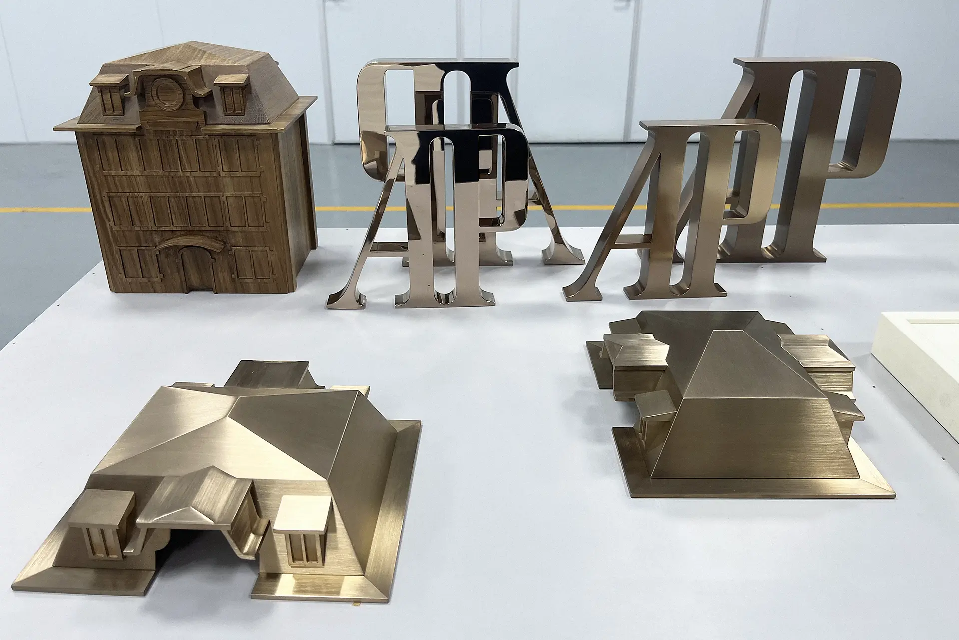 Bent stainless-steel building model and 3D sign components