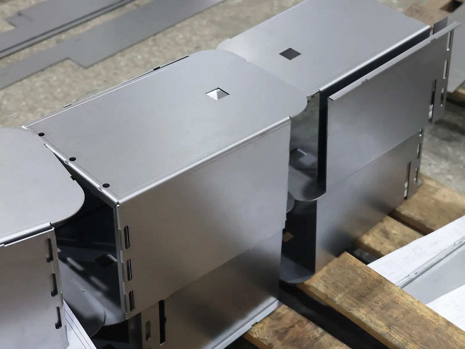 Finished stainless-steel enclosure parts formed on a CNC press brake