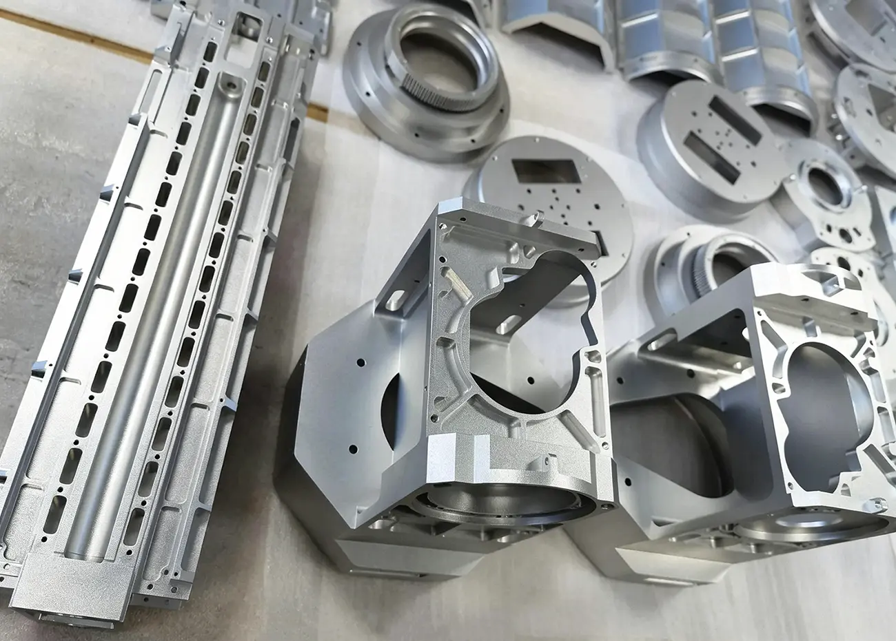 Production batch of CNC-milled aluminum housings, base plates, and structural components