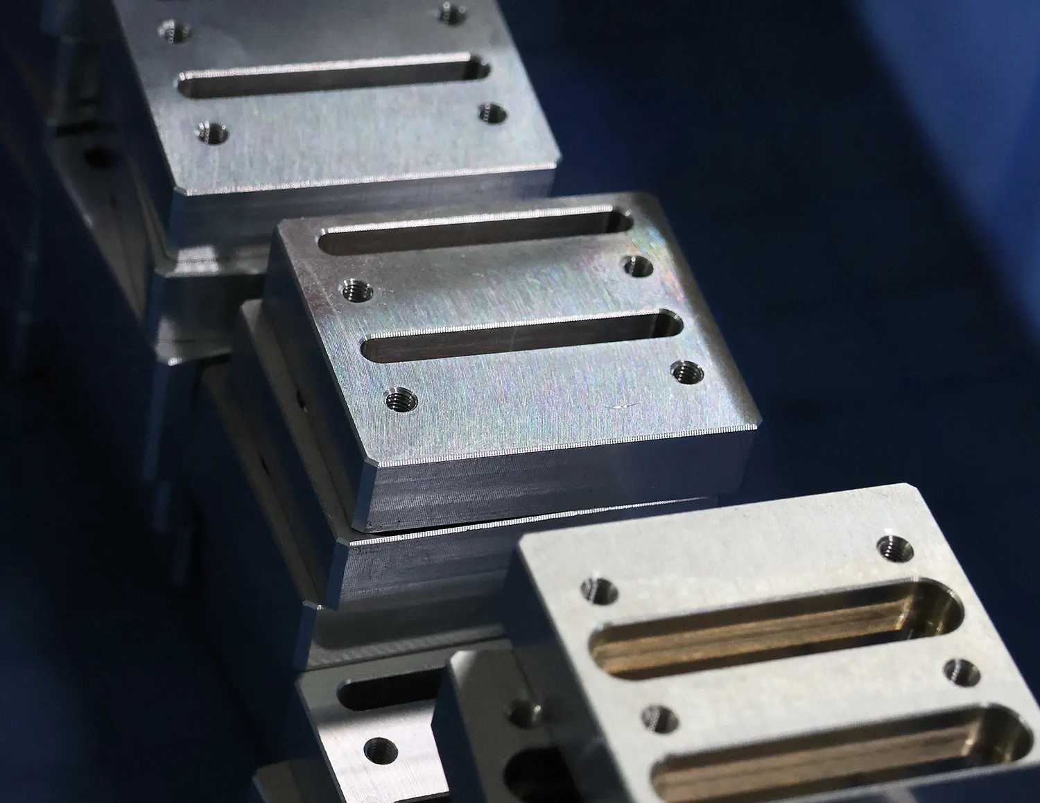 CNC-milled aluminum mounting blocks with threaded holes