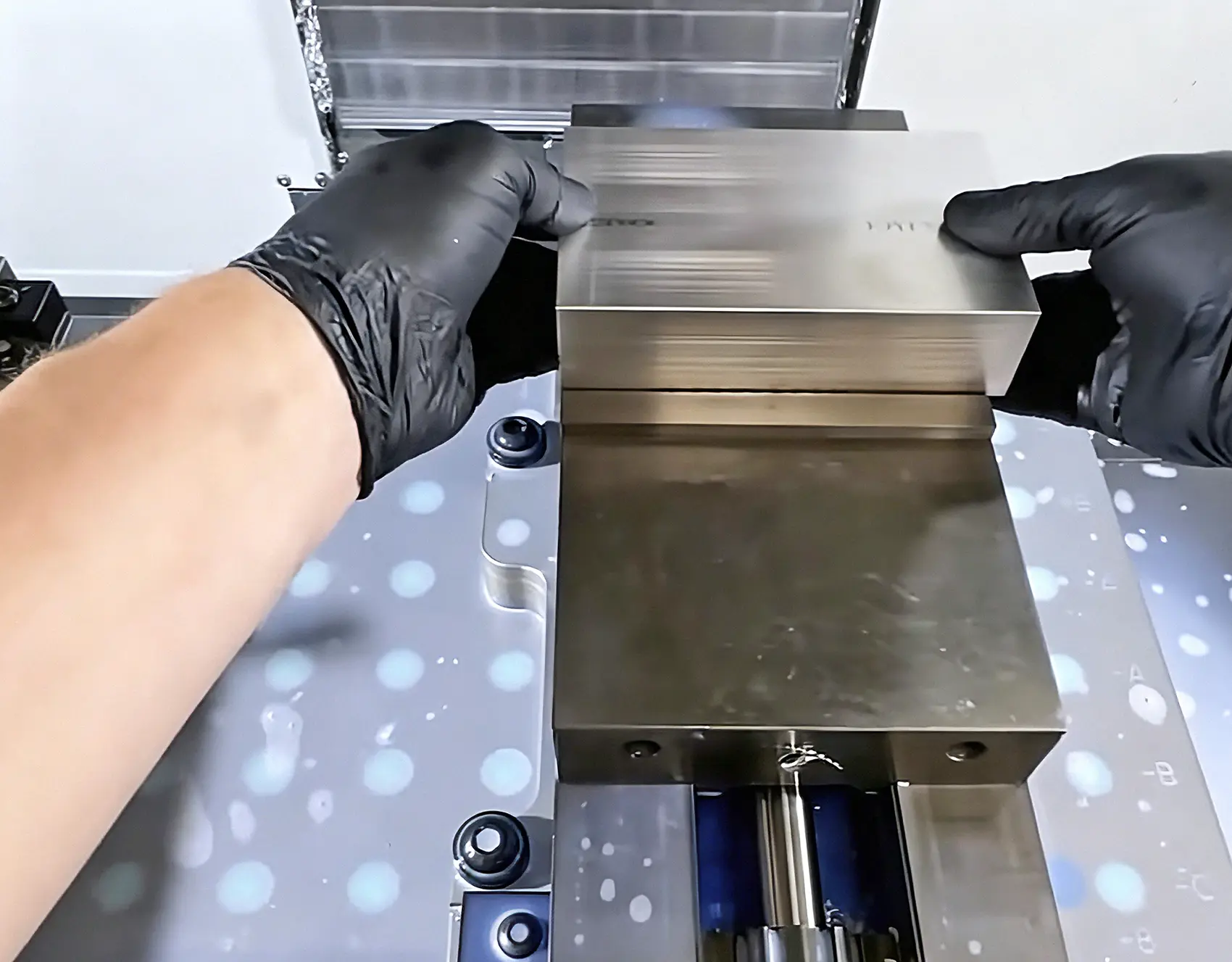 Technician securing a workpiece on a CNC milling fixture