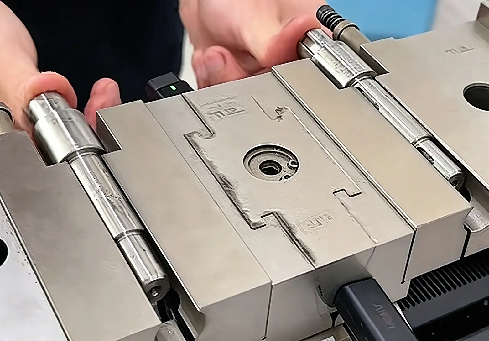 Operator mounting a workpiece in a CNC lathe chuck