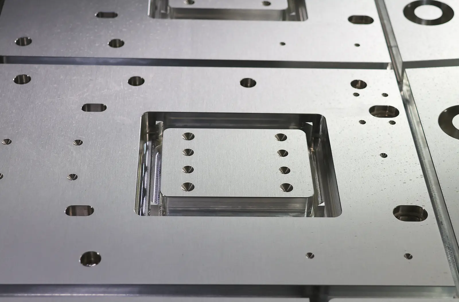 Steel plate with laser-cut slots, holes, and custom cutouts