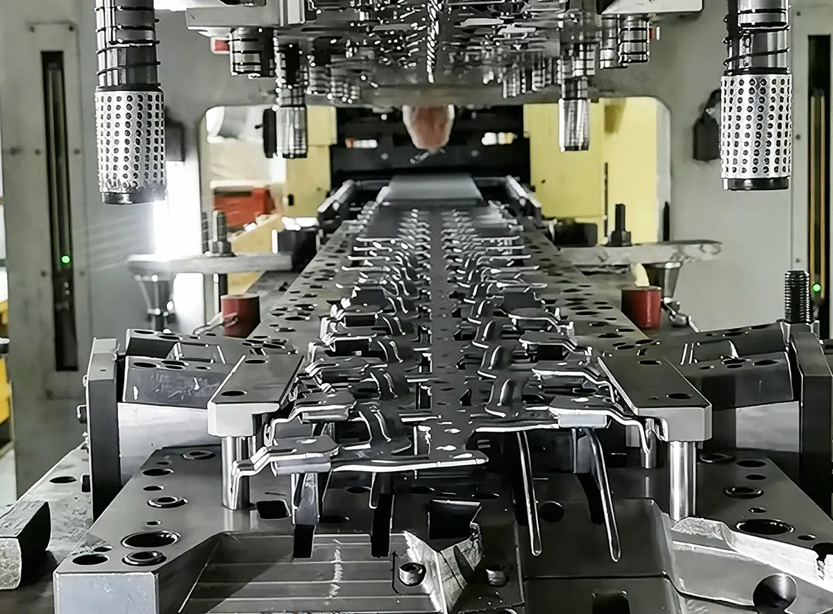 Progressive stamping die forming custom hardware clips from metal strip