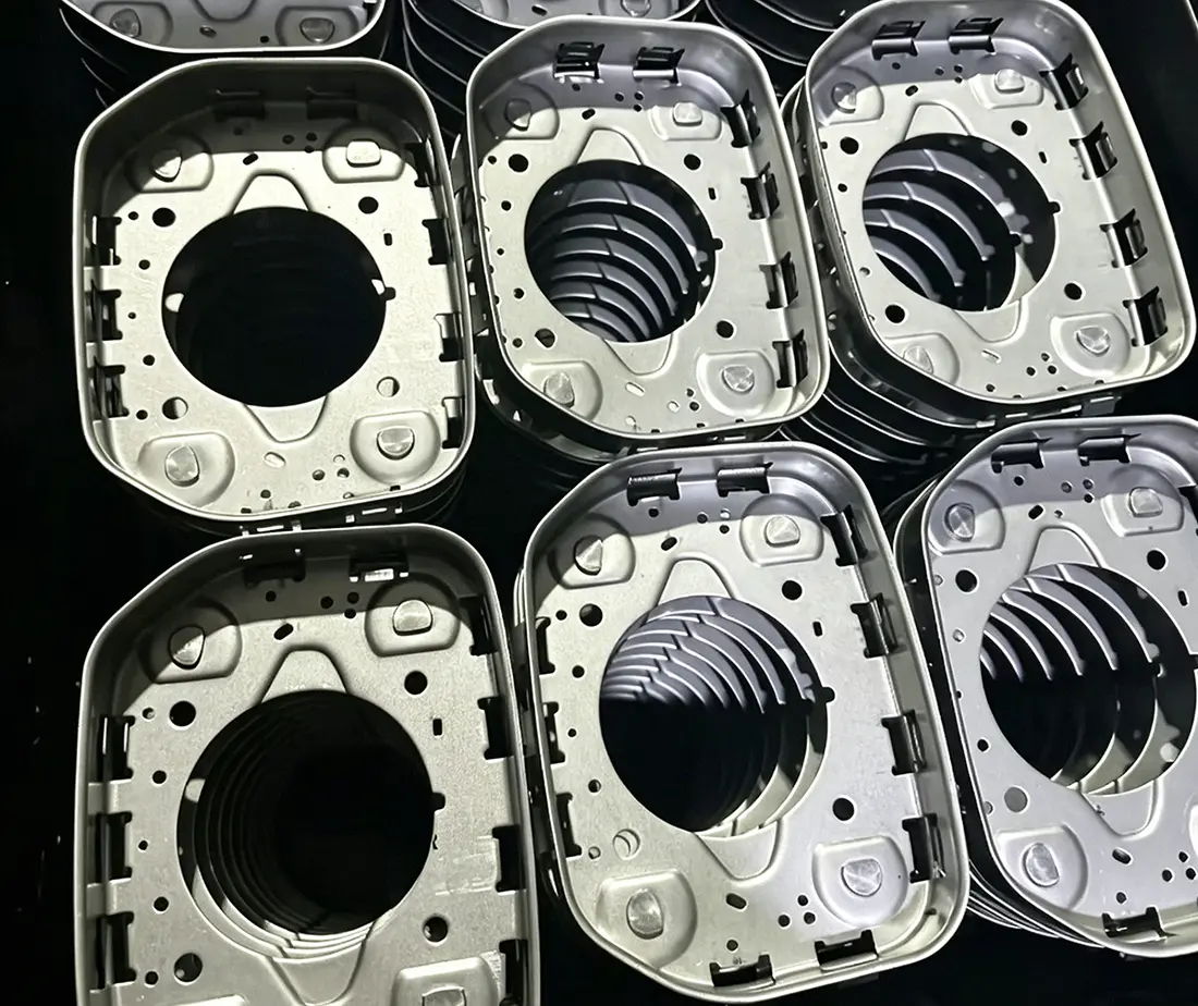 Deep-drawn stamped components with pierced openings