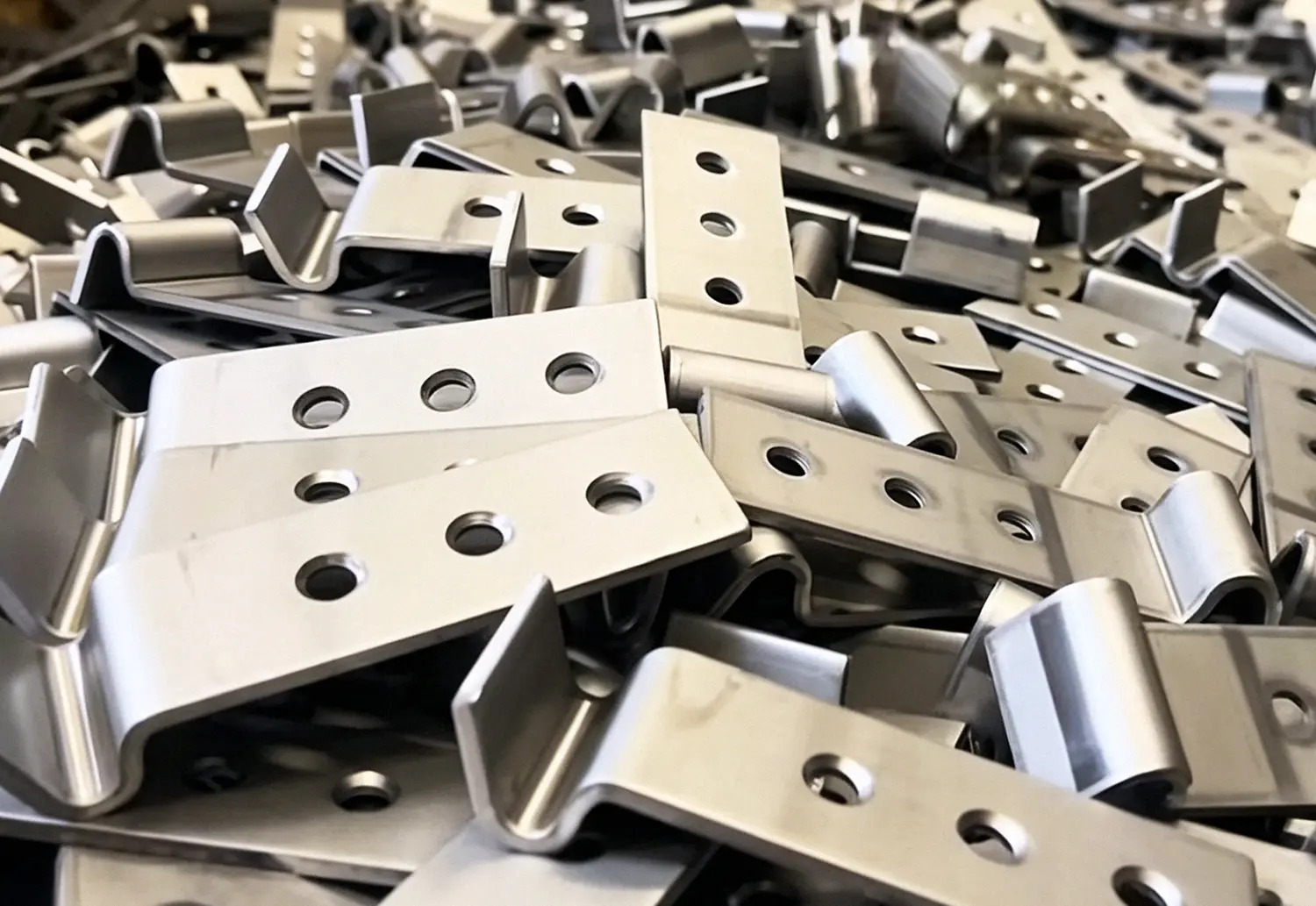 Production batch of punched and bent sheet-metal brackets